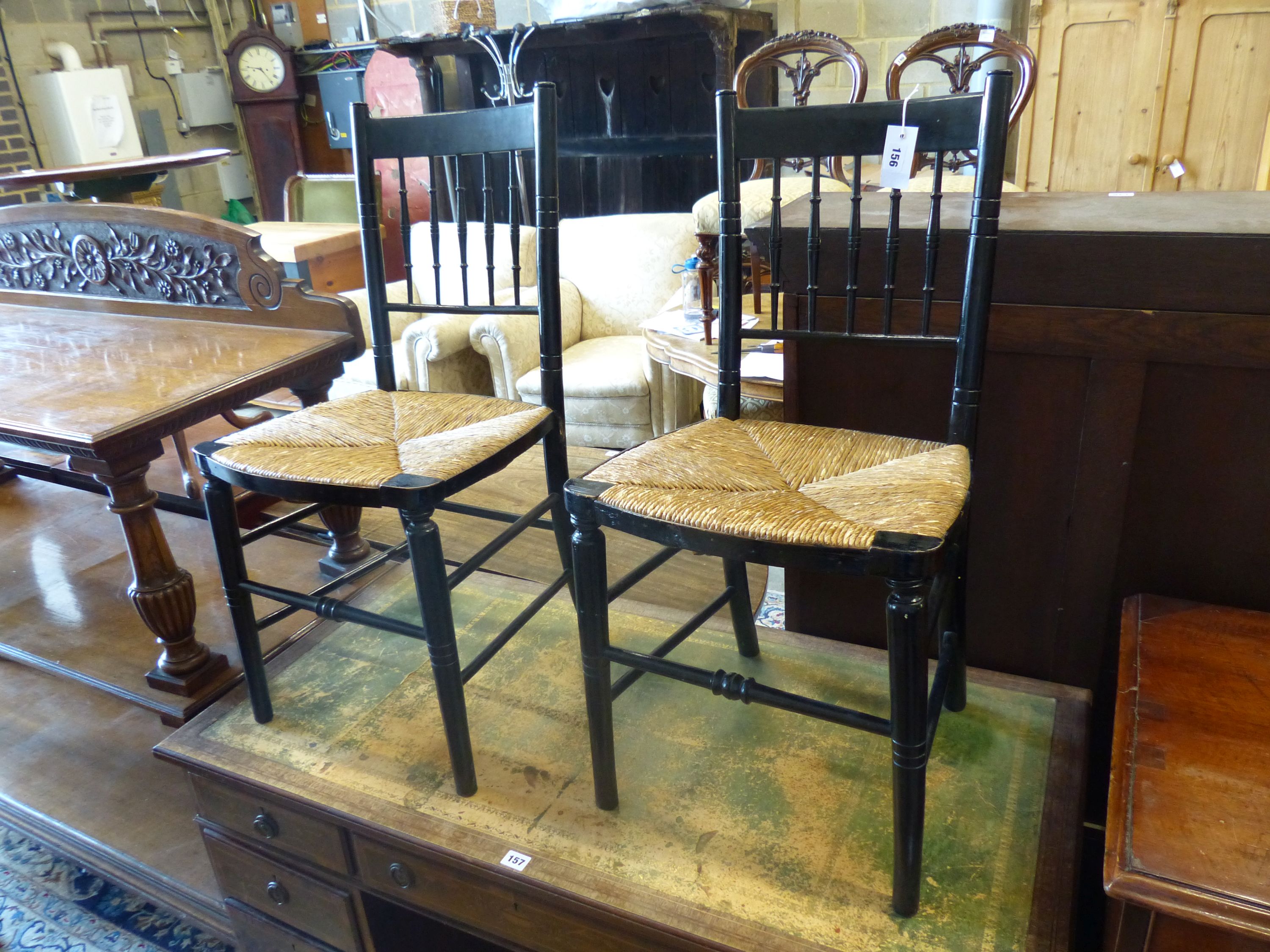 A pair of 19th century Sussex type ebonised rush seat chairs